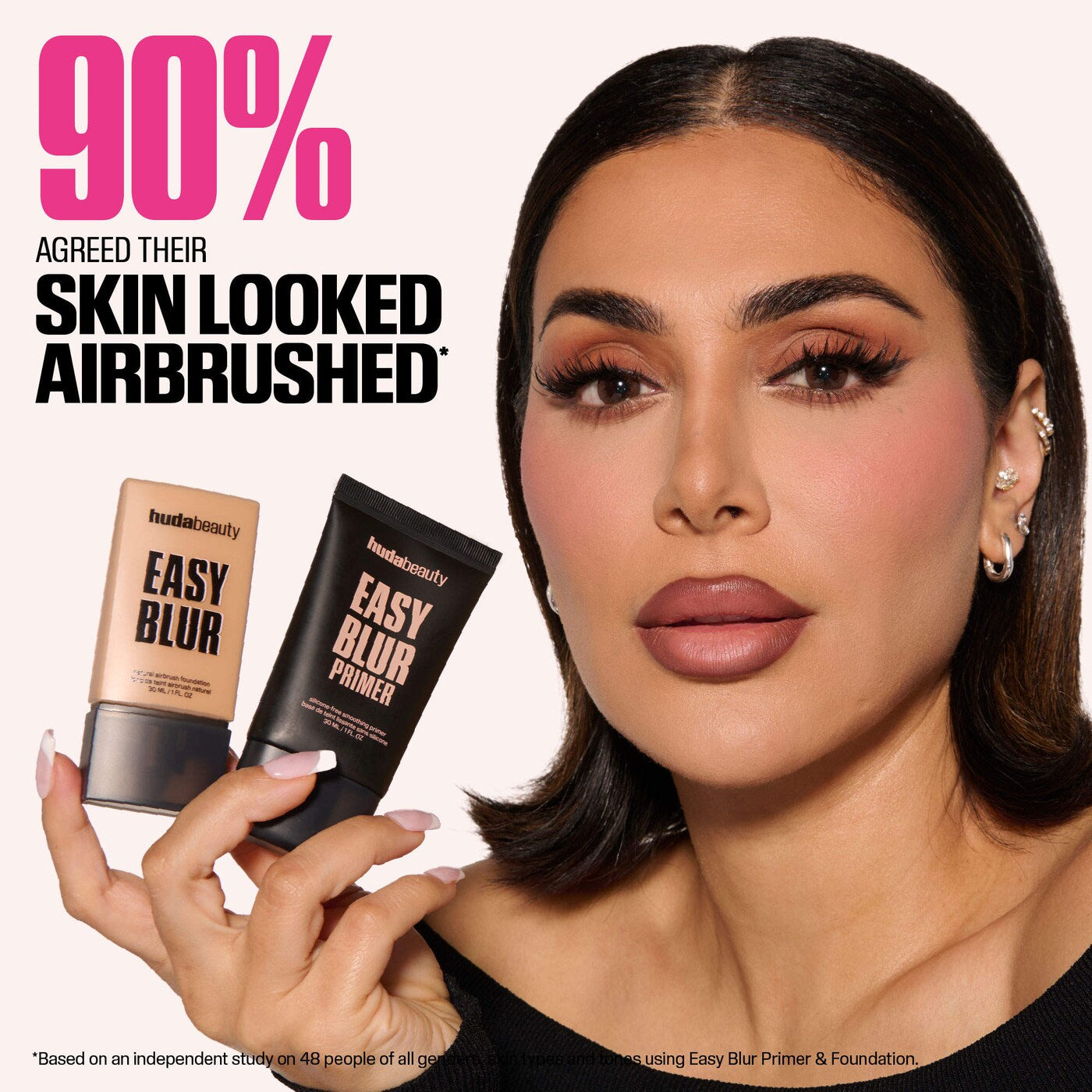 Model holding HUDA BEAUTY Easy Blur foundation and primer with text saying 90% agreed their skin looked airbrushed