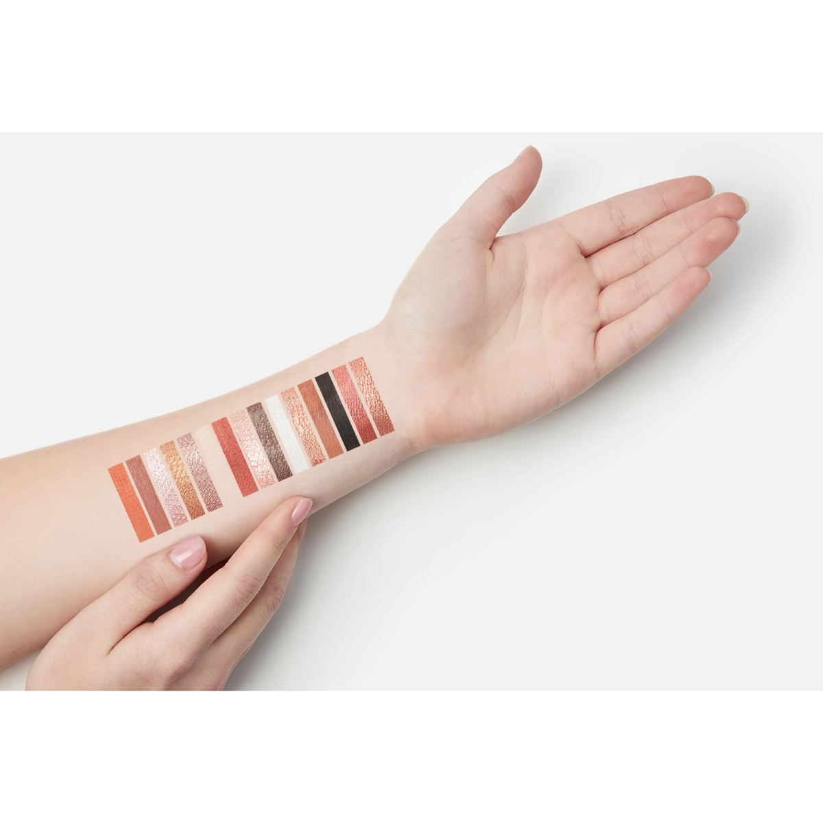 Makeup Revolution Maxi Reloaded Large It Up eyeshadow swatches showing matte and shimmer shades on an arm