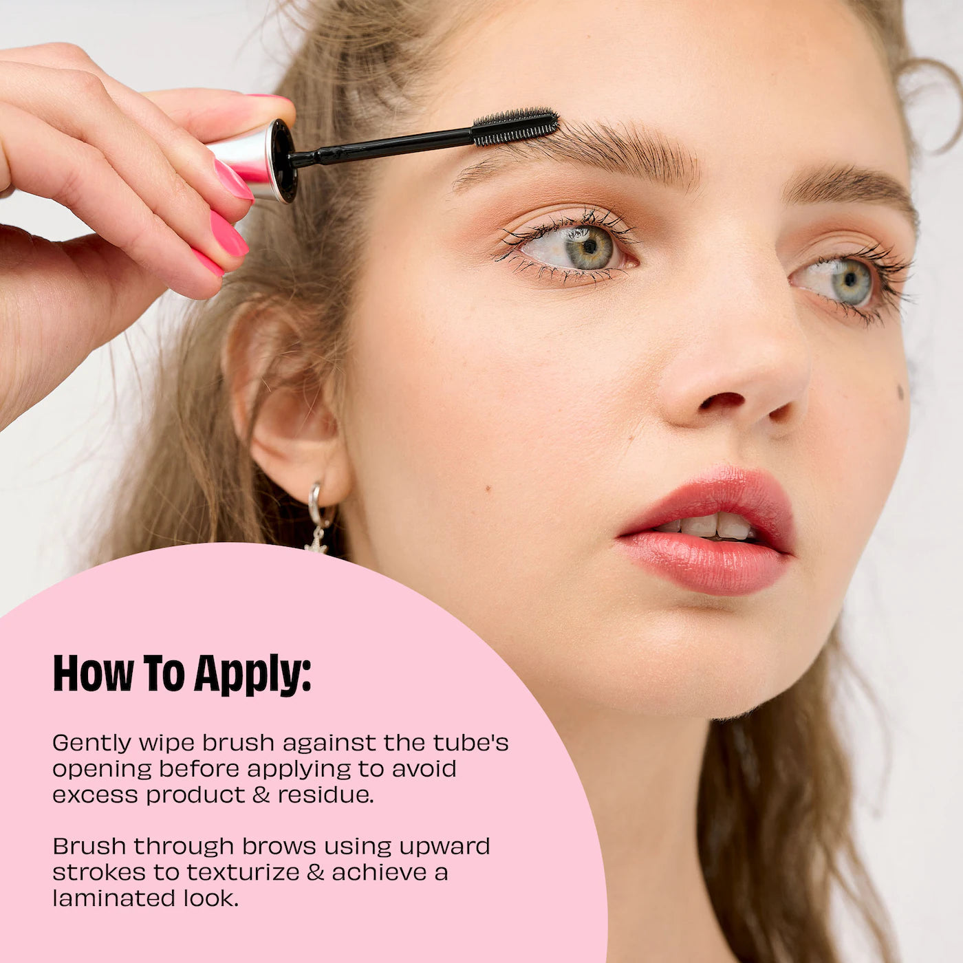 Applying Benefit 24-HR Brow Setter clear brow gel to lift eyebrows