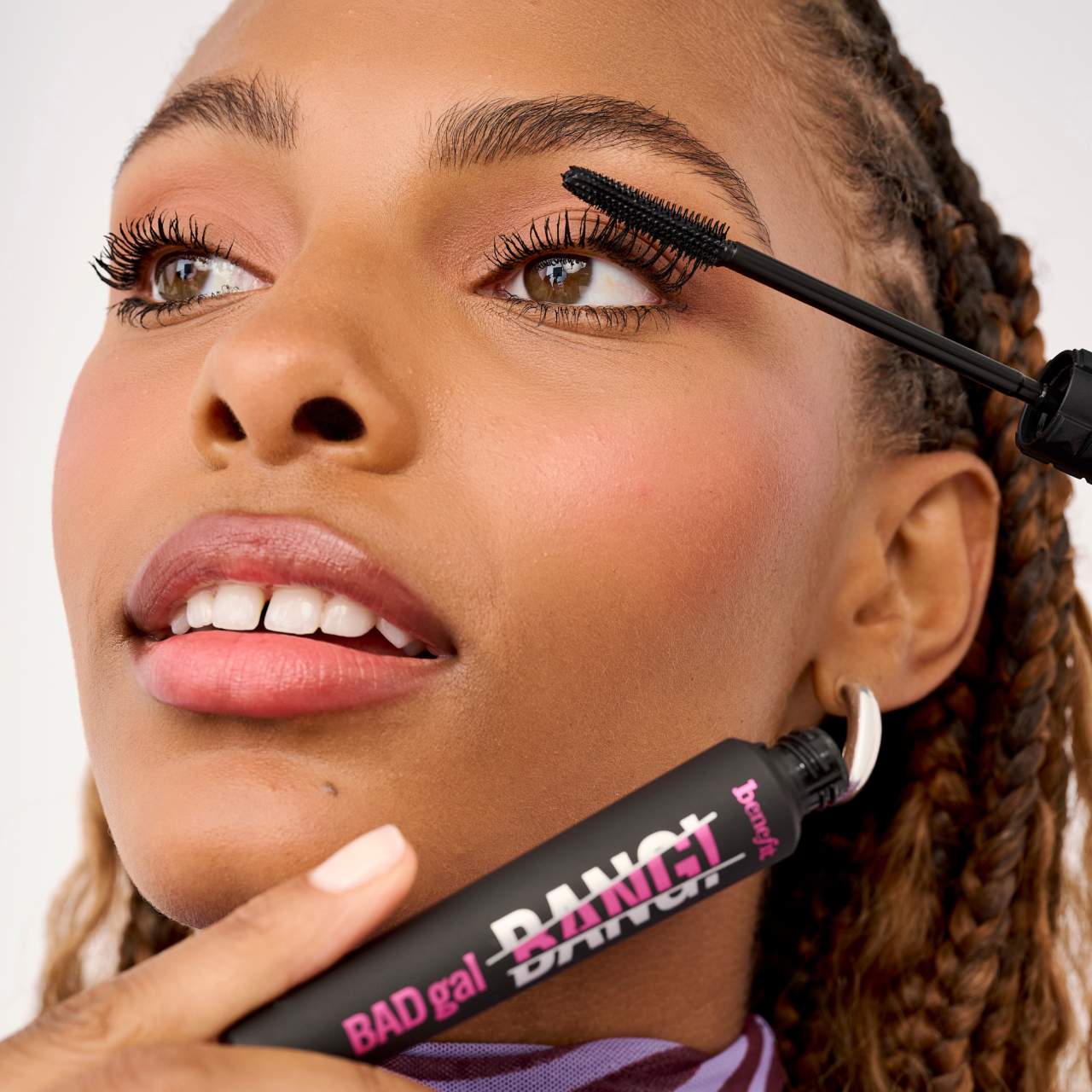Applying Benefit BADgal BANG mascara for volumized lashes