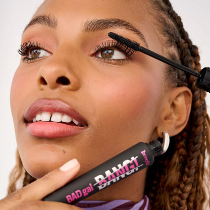 Applying Benefit BADgal BANG mascara for volumized lashes