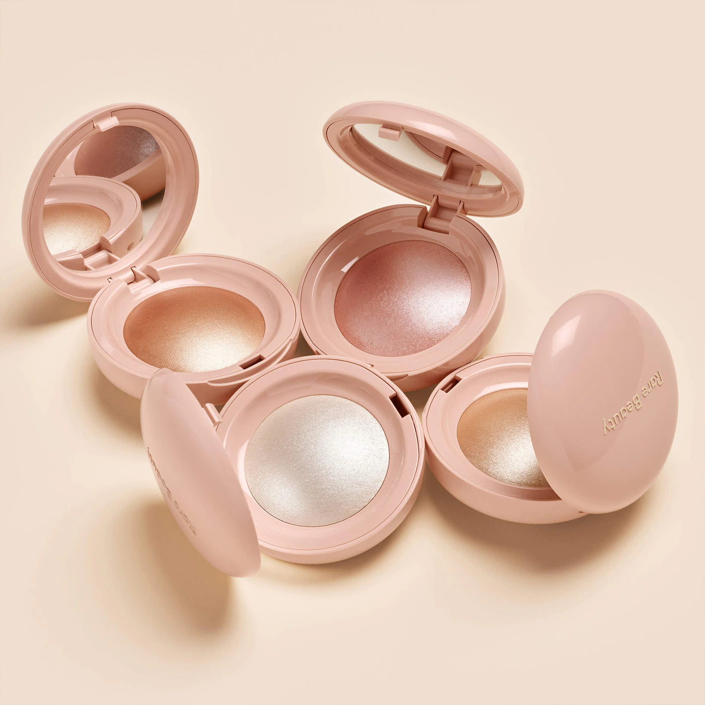 Rare Beauty Positive Light Silky Touch Highlighter compacts shown open in different shades
