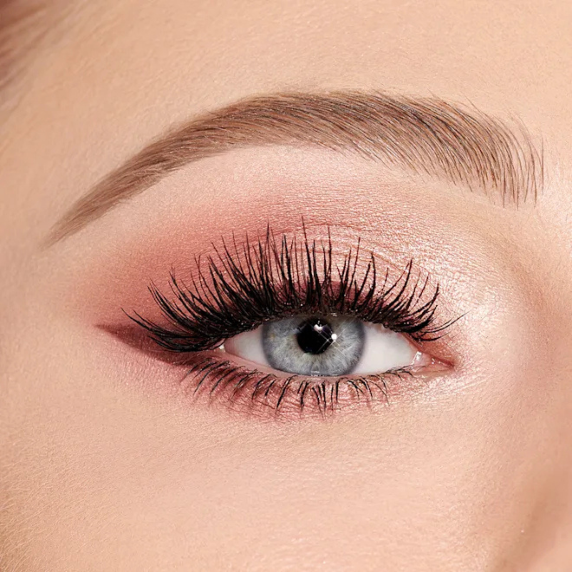 Shimmering rose-gold winged eye look using Charlotte Tilbury Pillow Talk Beautyverse Love Palette.