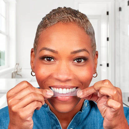 Woman applying Crest 3D Whitestrips in a bathroom setting