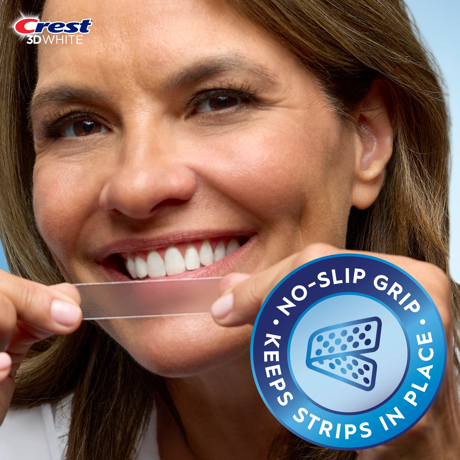 Woman holding a Crest 3D Whitestrips strip with no-slip grip badge