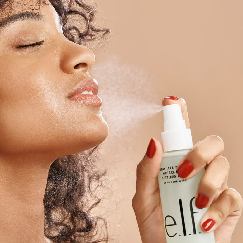 Woman spraying e.l.f Stay All Night Micro-Fine Setting Mist makeup setting spray